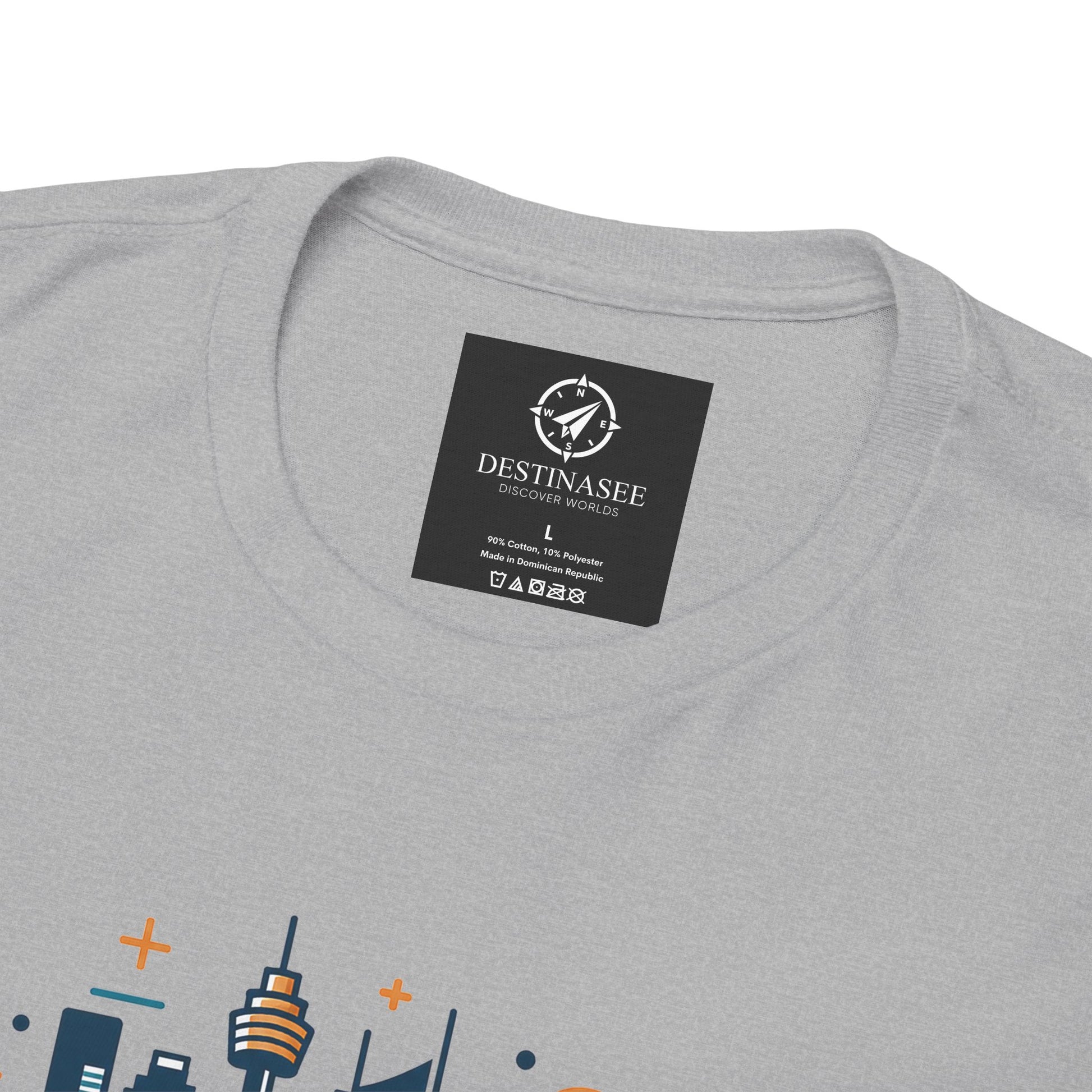 Light gray T-shirt close-up: round neck label patch and partial colorful Sydney skyline print.