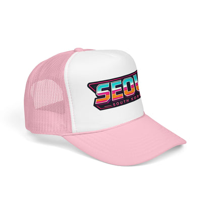 Pink and white mesh trucker hat with front patch logo reading “SEOUL SOUTH KOREA”.