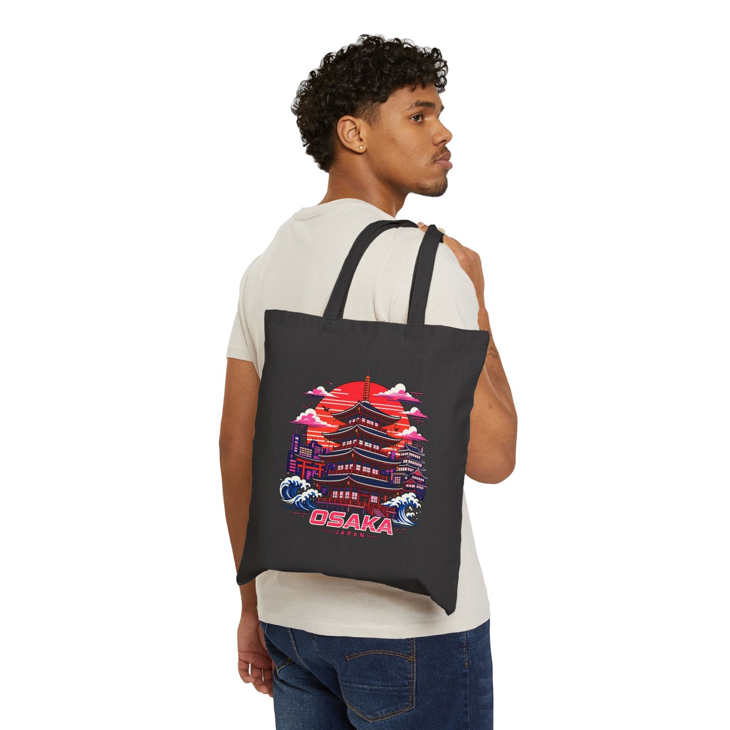 Black cotton tote bag with Osaka graphic worn over the shoulder by a man