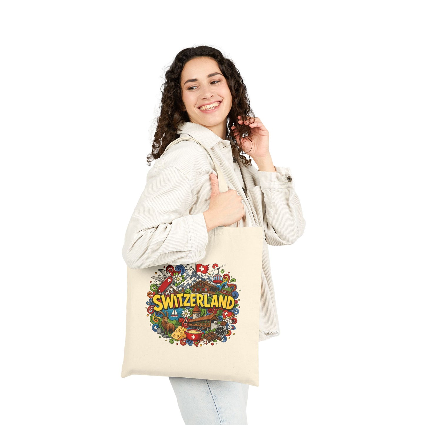 Natural canvas tote bag held in hands, with Switzerland graphic on the front