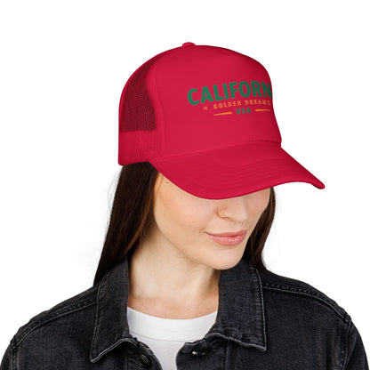 Red trucker hat with front logo text and mesh side panels, worn by model