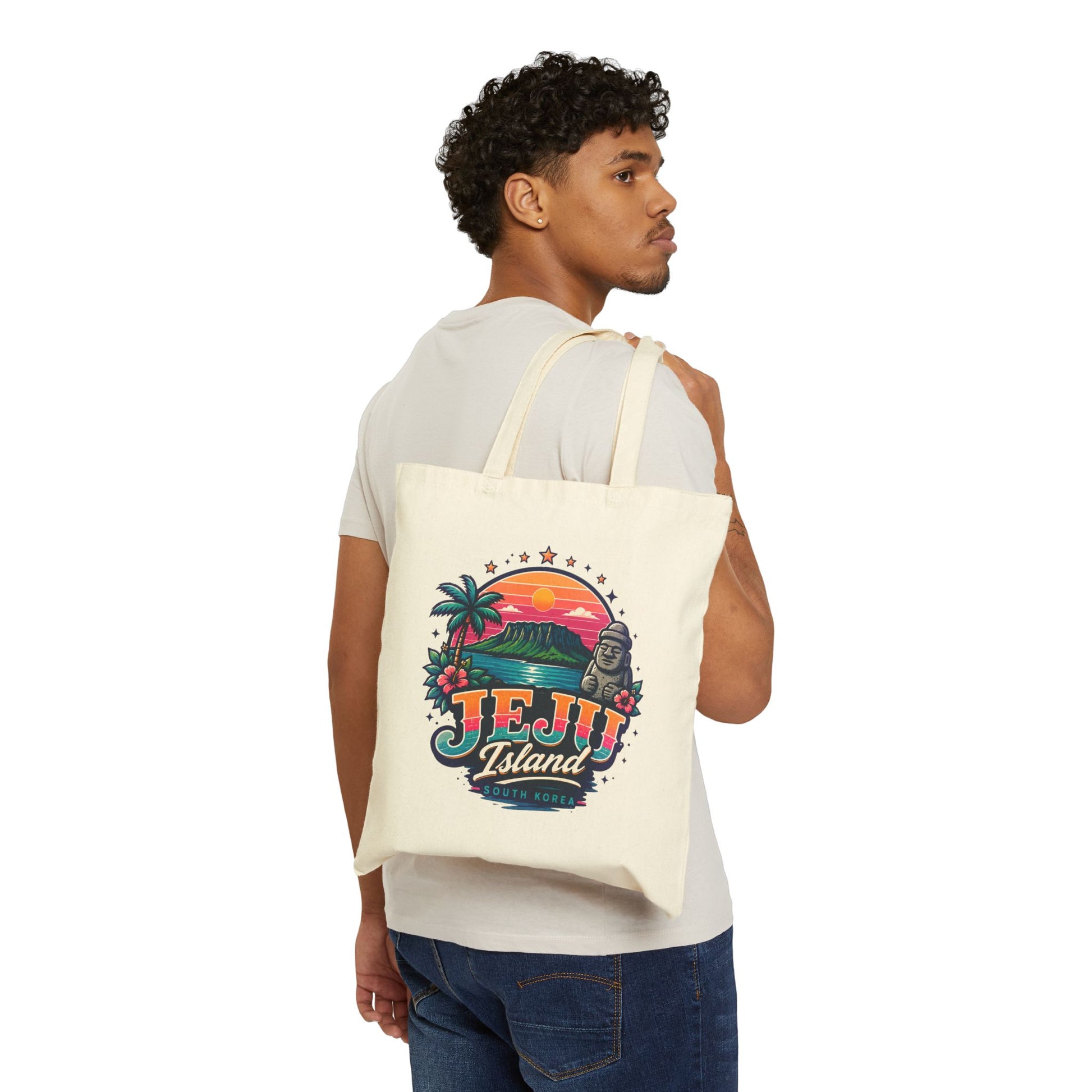 Natural canvas tote bag worn on back, featuring colorful Jeju Island front print