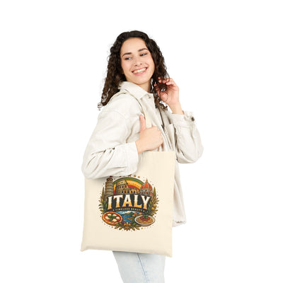 Natural travel tote bag with “Italy” colorful graphic, held by a person