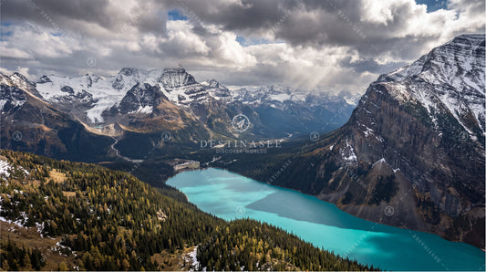 Desktop wallpaper with turquoise mountain lake, snow-capped peaks, and pine forest